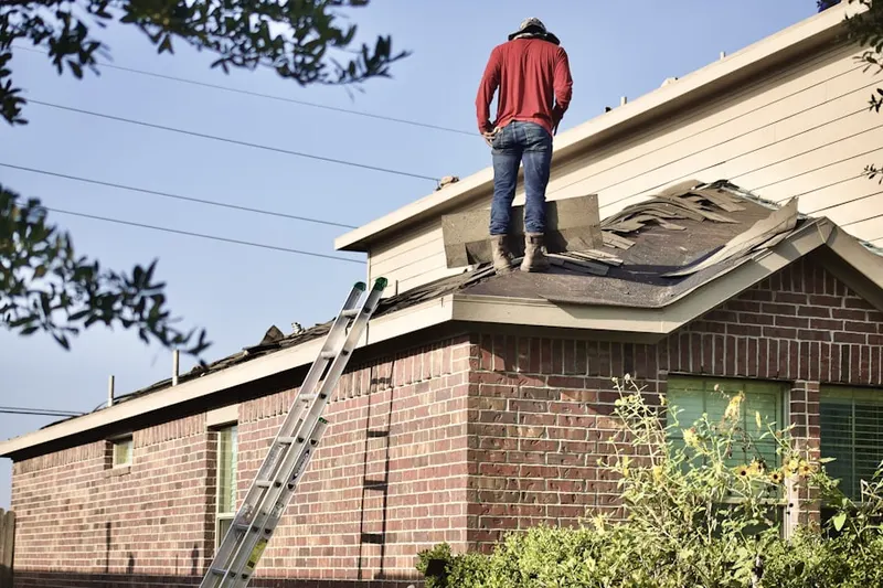 Professional roofer working on a residential roof in Galatia